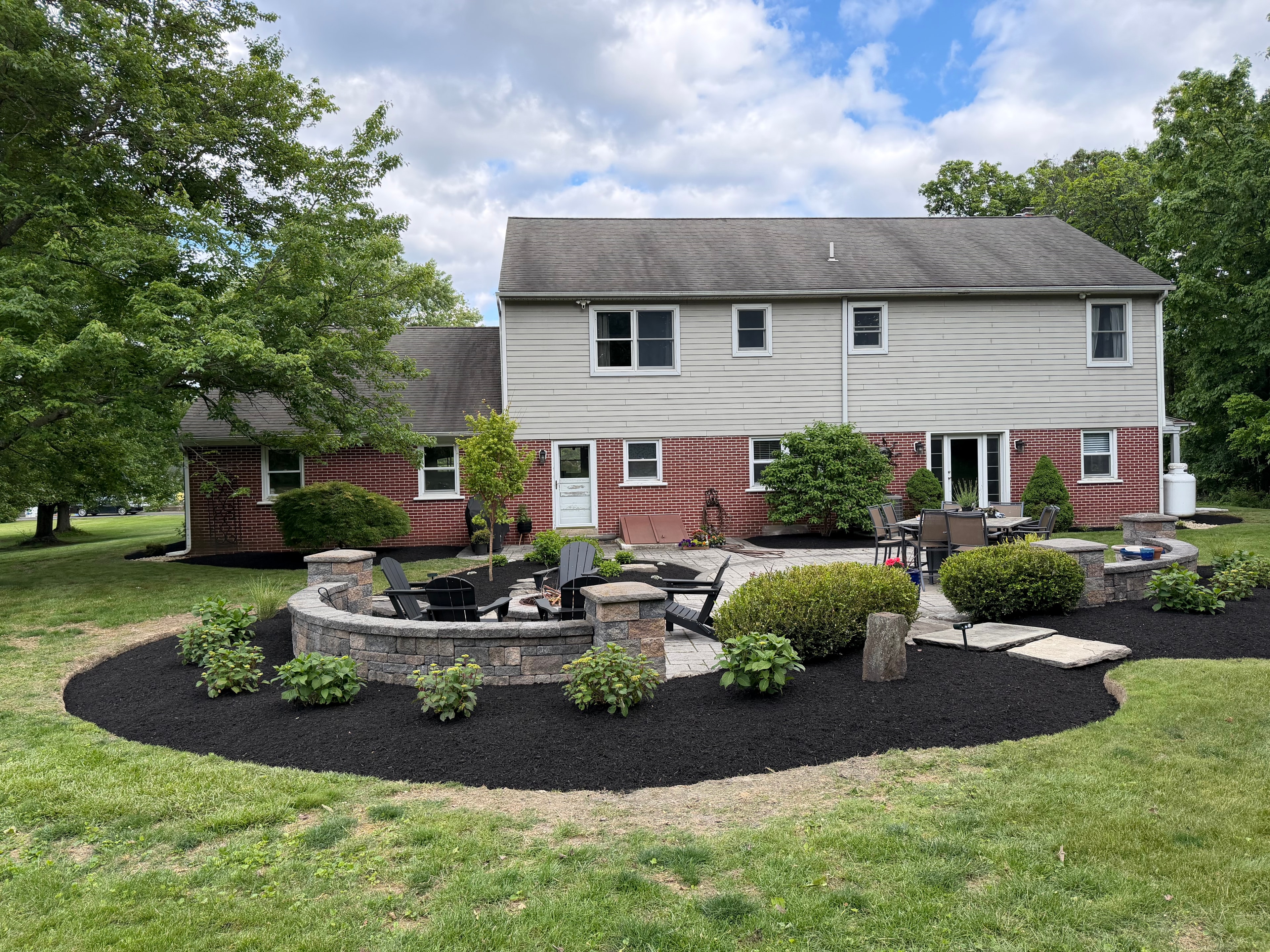 Evolution Lawn & Landscape fire pit patio and mulch bed installation